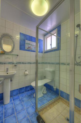 a bathroom with a shower and a toilet and a sink at Halls Creek Motel in Halls Creek