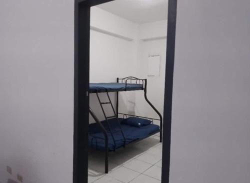 a mirror in a room with a bunk bed at Condo Unit 5A in Batangas City in Batangas City