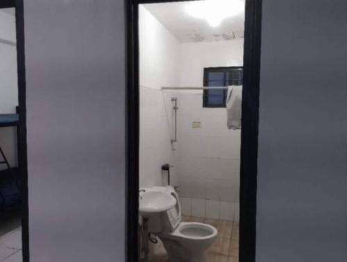a bathroom with a toilet and a sink at Condo Unit 5A in Batangas City in Batangas City