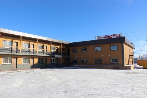 an empty parking lot in front of a hotel at Nights Inn Motel in Thunder Bay