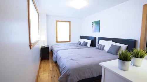 a bedroom with two large beds in it at Cottage on Crystal Beach 3BR & BBQ in Fort Erie