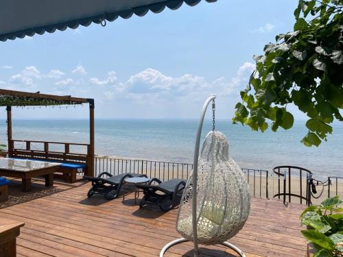 a view of the beach from the deck of a house at Water Front Beach House - 3BR w BBQ & Sunset in Fort Erie