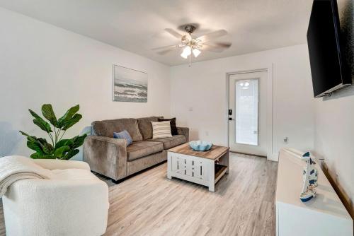 a living room with a couch and a table at The Cozy Cove I 3 min to Beach in Bradenton
