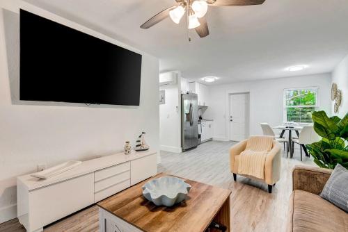 a living room with a flat screen tv on the wall at The Cozy Cove I 3 min to Beach in Bradenton