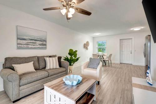 a living room with a couch and a table at The Cozy Cove II 3 Min to Beach in Bradenton