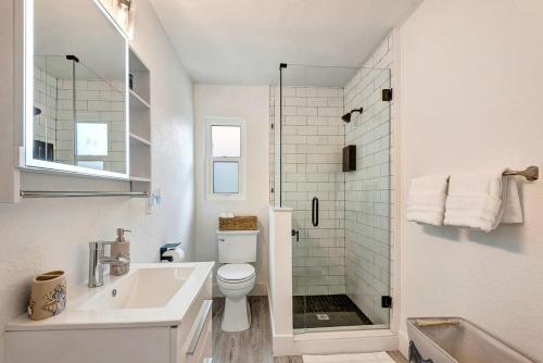 a bathroom with a toilet and a sink and a shower at The Cozy Cove II 3 Min to Beach in Bradenton