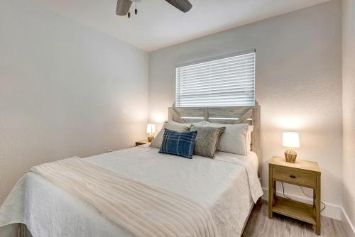a bedroom with a large white bed with two lamps at The Cozy Cove II 3 Min to Beach in Bradenton
