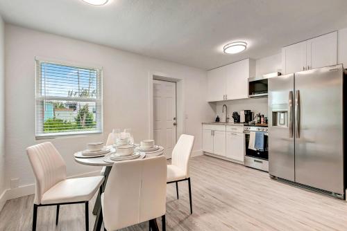 a kitchen with a table and chairs and a refrigerator at The Cozy Cove II 3 Min to Beach in Bradenton