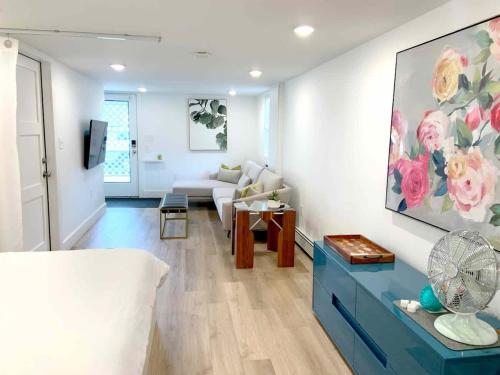 a living room with a couch and a table at Fresh Modern Garden Level Kittery Studio in Kittery