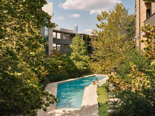 a swimming pool in the middle of a city at Hotel Magdalena in Austin