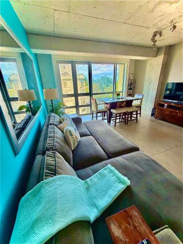 a living room with a large couch and a table at Spacious Loft-Sea view Atlantis by Stay Here PR in San Juan