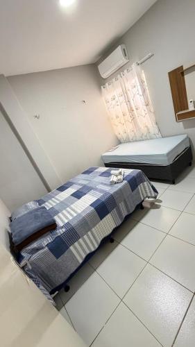 een slaapkamer met een bed en een raam in een kamer bij Paulinos Flat 02, Ubajara CE in Ubajara
