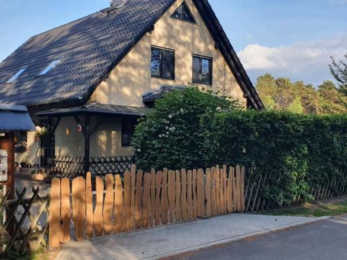a house with a wooden fence in front of it at Apartment Am Marsfeld by Interhome in Borkheide
