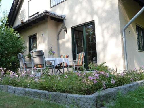 a table and chairs sitting outside of a house at Apartment Am Marsfeld by Interhome in Borkheide