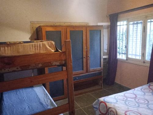 a bedroom with two bunk beds and a window at La Carioca in Villa Gesell
