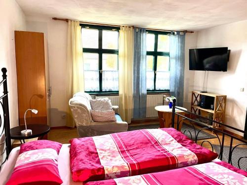 a living room with two beds and a tv at Apartment Spitzwegerich by Interhome in Kappe