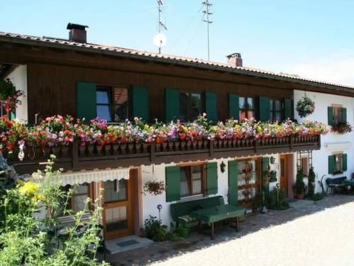 a building with flowers on the side of it at Apartment Igel by Interhome in Bad Bayersoien