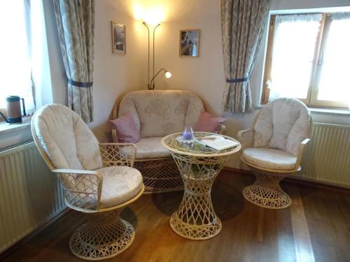 a living room with two chairs and a table at Apartment FeWo Bärli by Interhome in Bad Bayersoien