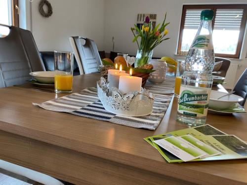 a table with a candle and a bottle of beer at Apartment Gästehaus Siebert by Interhome in Bad Brambach
