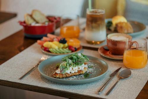 a table with a plate of food on a table at W Algarve in Albufeira