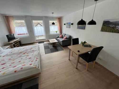 a bedroom with a bed and a living room at Apartment Haus Budinger by Interhome in Alf