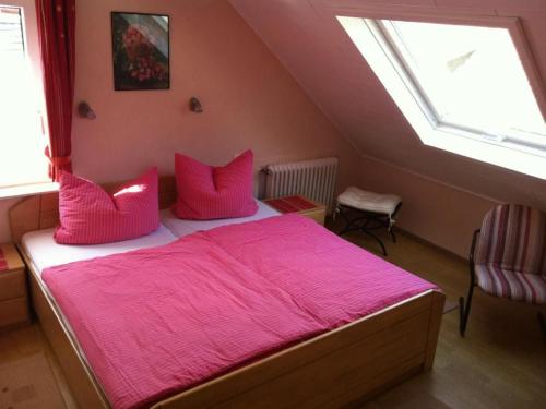a bedroom with a bed with pink sheets and a window at Apartment Haus Budinger by Interhome in Alf