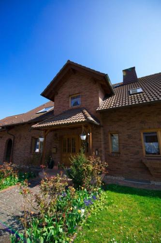 a large brick house with a roof at Apartment Fewo Dirks 2 by Interhome in Hemfurth-Edersee