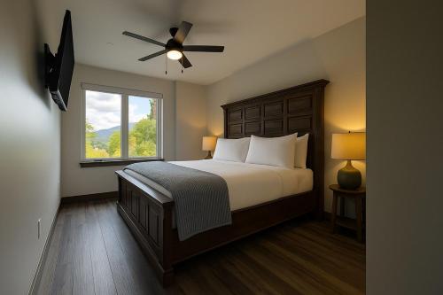 a bedroom with a bed with a ceiling fan and a window at NEW 2BR w/ Ski Views, Bunk Room & Resort Access in Durango Mountain Resort