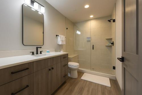 a bathroom with a sink and a toilet and a mirror at NEW 2BR w/ Ski Views, Bunk Room & Resort Access in Durango Mountain Resort