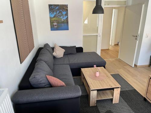 a living room with a couch and a table at Apartment Haus Budinger by Interhome in Alf