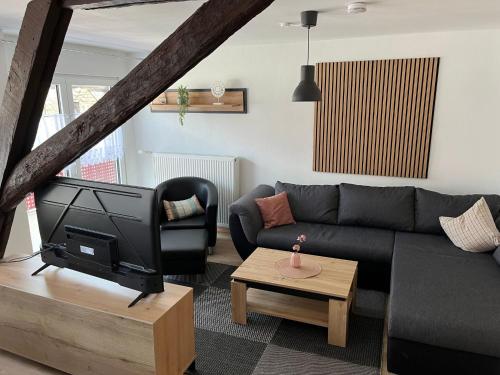 a living room with a couch and a tv at Apartment Haus Budinger by Interhome in Alf