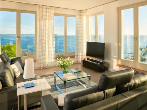 a living room with a couch and a television at Apartment Meerblick&SPA by Interhome in Ostseebad Sellin