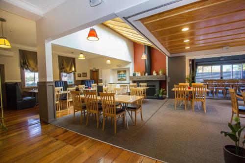 a dining room with wooden tables and chairs at The Greytown Hotel in Greytown