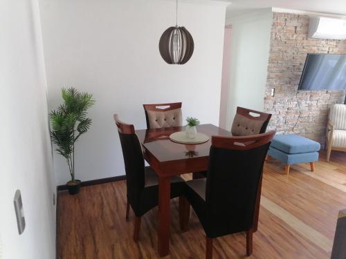 a dining room with a table and chairs at departamento vacacional in Arica