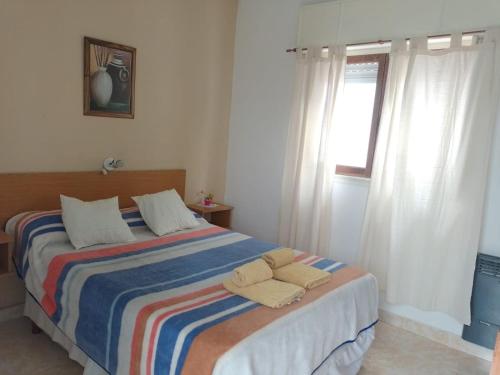 En eller flere senge i et værelse på Hotel El Parque