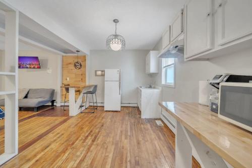 a kitchen with a table and a refrigerator at Cozy Private Suite in Worcester
