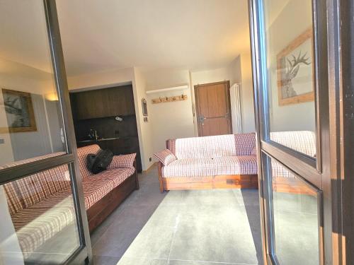 a living room with two couches and a couch at Moda Apartments Cimaboschi in Sestriere