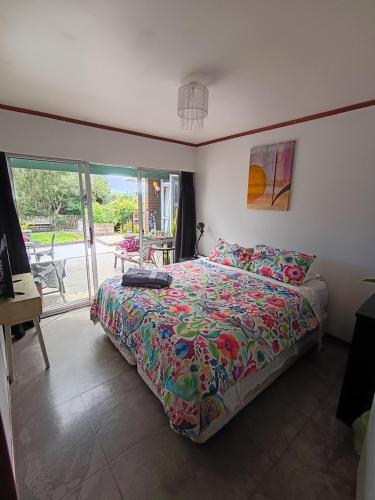 a bedroom with a bed with a colorful comforter at The Grays in Whangarei