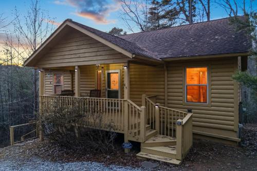 a log cabin with a porch and a staircase at Mountain Cabin Fireplace Views Fire Pit in Sautee Nacoochee