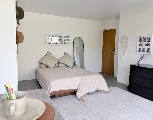 a white bedroom with a bed and a table at Potts Point Cozy Studio Near Parks Water in Sydney