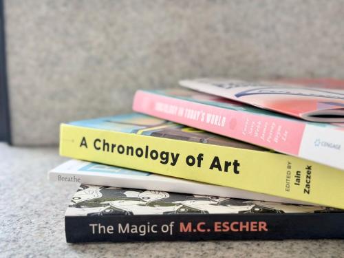 four books stacked on top of each other at Potts Point Cozy Studio Near Parks Water in Sydney