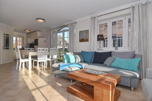 a living room with a couch and a table at Gartenweg 3d in Tinnum