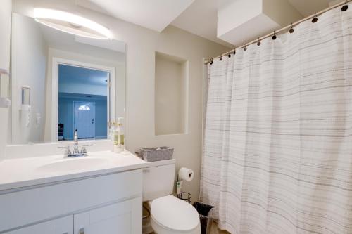 a bathroom with a sink and a toilet and a mirror at Work & Explore, Cozy Unit 5 Mi to UMD! in Lanham