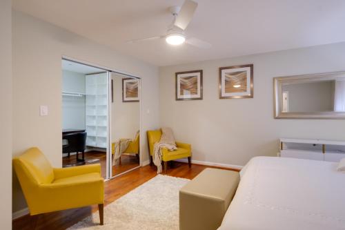 a bedroom with a bed and a couch and a chair at Great for Gatherings! Modern Lanham Duplex in Lanham