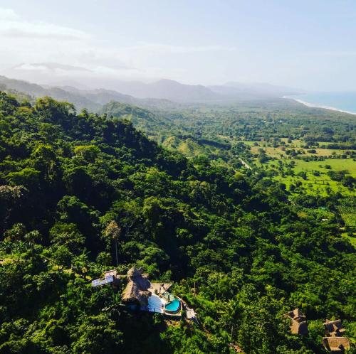 an aerial view of a lush green valley with a house at Mirador Puerto Alto in Buritaca
