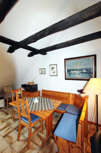 a living room with a wooden table and chairs at Lachmöwe in Hörnum