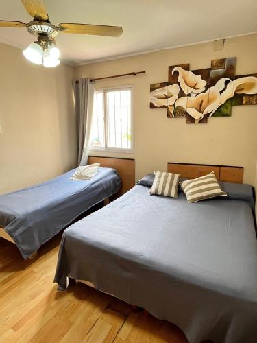 a bedroom with two beds and a ceiling fan at Casa Premium con Cochera en Mendoza Ideal Familias Hasta 7 pers in Mendoza