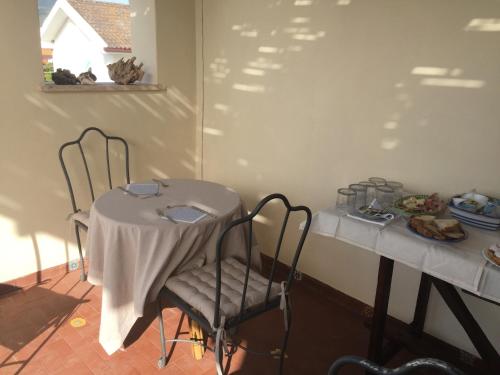 a table with a white table cloth on top of it at Nel Sole di Daniel in San Felice Circeo
