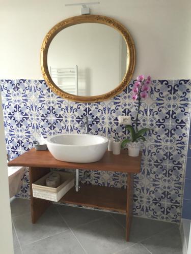 a bathroom with a sink and a mirror on a wall at Nel Sole di Daniel in San Felice Circeo