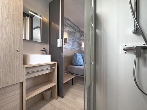 ein Badezimmer mit Waschbecken und Spiegel in der Unterkunft Feriendorf Seeblick - Tiny Chalet Nr 10 in Neunburg vorm Wald